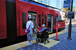 Unidentified Trolley passenger using a mobility device while boarding the Green Line Trolley to Santee. Unidentified Trolley passenger using a mobility device while boarding the Green Line Trolley to Santee.