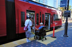 Unidentified Trolley passenger using a mobility device while boarding the Green Line Trolley to Santee.