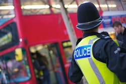 A West Midlands Police officer at a bus stop.