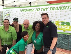 Planning and marketing staffers show off the number of visitors who stopped by to sign the &ldquo;Try Transit&rdquo; pledge.