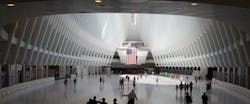 The World Trade Center Transportation Hub was designed by architect Santiago Calatrava. The large, open mezzanine is under the National September 11 Memorial plaza. The World Trade Center Transportation Hub was designed by architect Santiago Calatrava. The large, open mezzanine is under the National September 11 Memorial plaza.