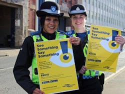 Safer Travel Police Community Support Officers Tash Luczak and Jennie Beechey with the See Something Say Something posters.