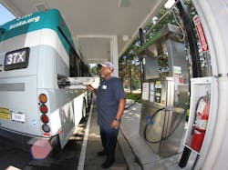 A mechanic fueling a CNG vehicle at KCATA in May 2015.