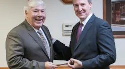 Brookville CEO and Chairman Dalph McNeil (left) passes the symbolic gavel to President Rick Graham.
