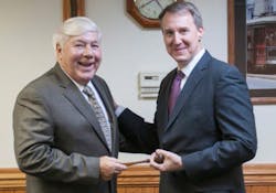 Brookville CEO and Chairman Dalph McNeil (left) passes the symbolic gavel to President Rick Graham.