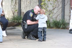Dallas Area Rapid transit officer with youth. Dallas Area Rapid transit officer with youth.