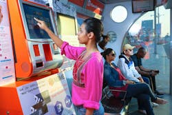 An RTA rider using the Smart Shelters service while waiting. An RTA rider using the Smart Shelters service while waiting.