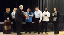 Iliana Mena receives her award.