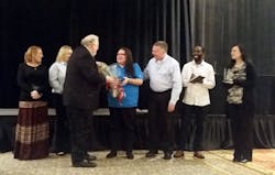 Iliana Mena receives her award. Iliana Mena receives her award.