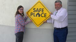NCRTD Chair and Town of Taos Mayor, Daniel Barrone (R), and Stacey McGuire (L), NCRTD Planning, Projects &amp; Grants Manager, display a copy of the Safe Place sign that has been placed on the RTD fleet of buses.