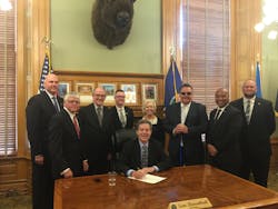 Kansas Gov. Sam Brownback (center) signs House Bill 2096 into law. Also in attendance are Paul Snider (KCATA), Sen. Mike Petersen (Chair of the Transportation Committee), Tuck Duncan (Kansas Public Transit Association), Josh Powers (Johnson County, Kan.), Sen. Pat Pettey (Ranking minority member of Transportation Committee), Robbie Makinen (KCATA), Sam Desue (KCATA), and Cory Davis (KDOT). Kansas Gov. Sam Brownback (center) signs House Bill 2096 into law. Also in attendance are Paul Snider (KCATA), Sen. Mike Petersen (Chair of the Transportation Committee), Tuck Duncan (Kansas Public Transit Association), Josh Powers (Johnson County, Kan.), Sen. Pat Pettey (Ranking minority member of Transportation Committee), Robbie Makinen (KCATA), Sam Desue (KCATA), and Cory Davis (KDOT).