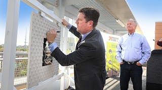 The signing of a commemorative plaque marks the start of construction on the 50th St/Washington Valley Metro Rail station. Phoenix Mayor Greg Stanton adds his signature to the plaque, which will be incorporated into the new station, as the owner of Stockyards Restaurant and Jokake Real Estate Services Gary Smith looks on.