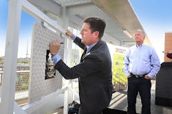 The signing of a commemorative plaque marks the start of construction on the 50th St/Washington Valley Metro Rail station. Phoenix Mayor Greg Stanton adds his signature to the plaque, which will be incorporated into the new station, as the owner of Stockyards Restaurant and Jokake Real Estate Services Gary Smith looks on.