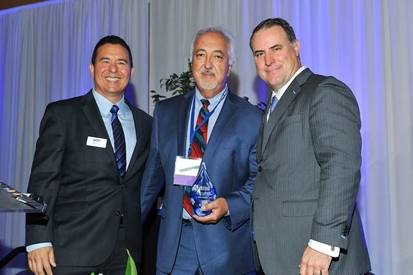 Coalition for Clean Air President & CEO Dr. Joseph Lyou, BYD Heavy Industries Senior Vice President Macy Neshati, and Coalition for Clean Air Board Chair Todd Campbell pose with BYD&rsquo;s Corporate Leadership Award at the 2017 California Air Quality Awards in Los Angeles on June 9.