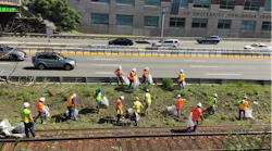 Crews collect trash between the Framingham/Worcester Line and the Massachusetts Turnpike.