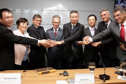 Tyler Li, Stella Li, Marcelo Knobel (center), and Xin Guobin celebrate the cooperation. Tyler Li, Stella Li, Marcelo Knobel (center), and Xin Guobin celebrate the cooperation.