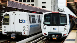 Train from current fleet at left and a new train car, right, still in testing mode.