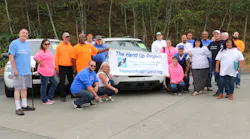 Staff and volunteers for The Hand Up Project celebrate their new van.