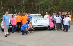 Staff and volunteers for The Hand Up Project celebrate their new van. Staff and volunteers for The Hand Up Project celebrate their new van.
