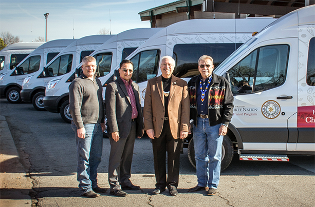(L-R) Cherokee Nation Department of Transportation Director Michael Lynn, Secretary of State Chuck Hoskin Jr., Principal Chief Bill John Baker and Deputy Chief S. Joe Crittenden get a look at six new Ford 350 Transit vans.