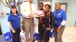 County Transportation Director Chris Walton presents Covenant House residents who are parents of a toddler, with one of the donated items collected through the BCT 2nd Annual Toy Drive.