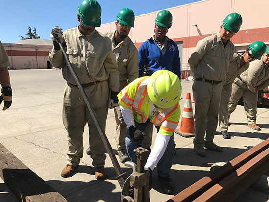 An instructor demonstrates a track jack at Cypress Mandela Training Center.