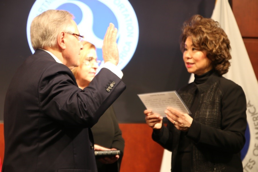 Ronald Batory being sworn in by aecretary Elaine Chao.