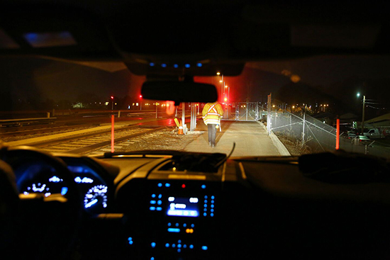 BART engineers work in the field as well as in the office, such as the engineer shown here in reflective vest preparing to oversee track work during the overnight period when BART trains are not in service.