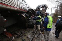 NTSB investigators assess the damage caused by the collision of an Amtrak train and a CSX train Feb. 4, 2018.