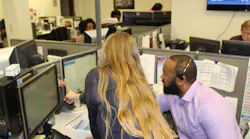 Palm Tran Executive Director Clinton B. Forbes receives guidance from seasoned agents as he answers calls in Palm Tran’s fixed-route customer service department.