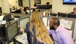 Palm Tran Executive Director Clinton B. Forbes receives guidance from seasoned agents as he answers calls in Palm Tran’s fixed-route customer service department. Palm Tran Executive Director Clinton B. Forbes receives guidance from seasoned agents as he answers calls in Palm Tran’s fixed-route customer service department.