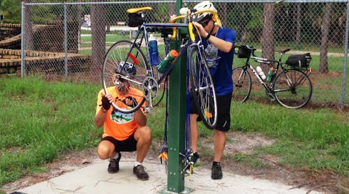 The pearl-green, 6-foot-tall stations are equipped with a tool kit, foot-operated air pump and psi gauge, plus two bars that allow riders to hang their bikes while they repair them.