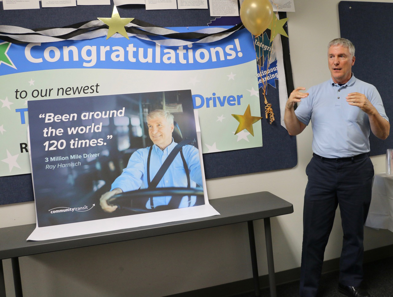 Harnisch, standing next to the photo that will be featured on the sides of buses throughout 2018, thanking the team that helped him reach this achievement.