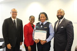 Director of Operations Sean Smith, Assistant County Administrator Faye W. Johnson, Bus Operator Graduate Aisha Marbury and Executive Director Clinton B. Forbes pose at a ceremony.