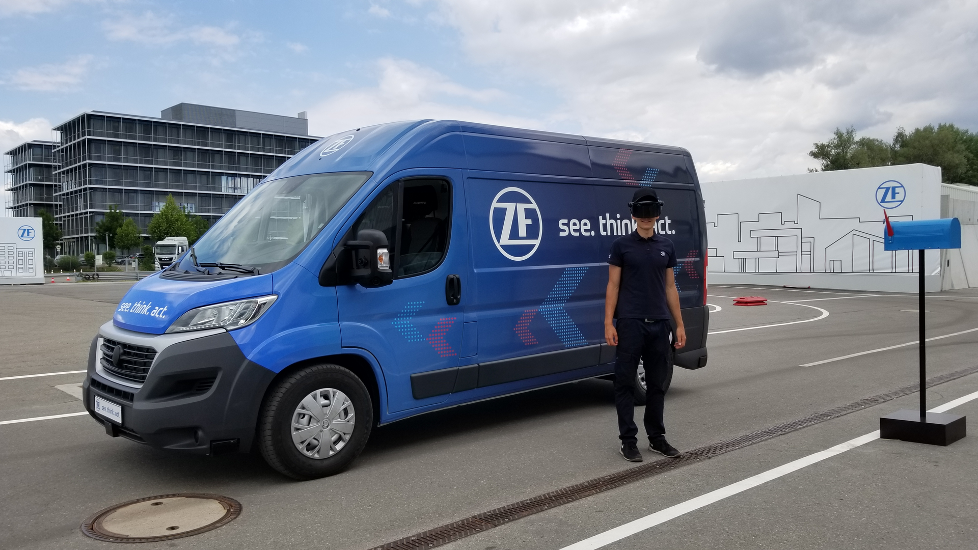 In ZF's Innovation Van, autonomous technology is used to improve the first-last mile efficiency of package delivery. (For the demonstration, the face shield worn is different than their actual design which more closely resembles glasses. They could not be shown due to propriety information.)