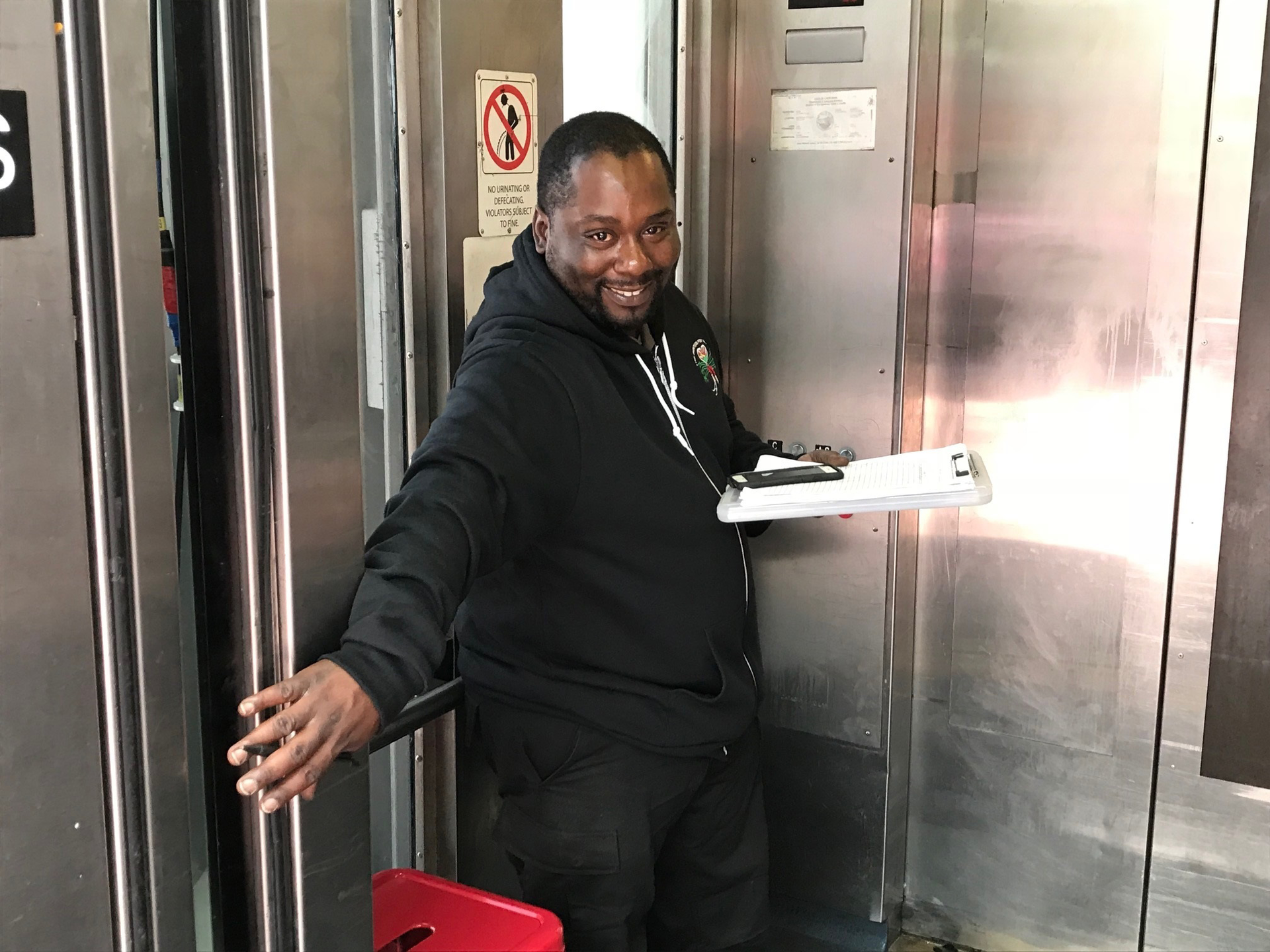 Elevator attendant Charles Jones greets customers at Powell Street Station in July 2018.