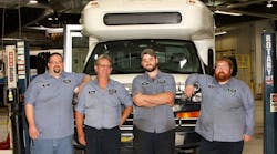 Four Heroes (pictured, L to R): Doug Gougeon, Larry Lautner, Steven Markel and John Baxter in front of a Blue Water Area Transit bus in the agency&rsquo;s garage.