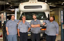 Four Heroes (pictured, L to R): Doug Gougeon, Larry Lautner, Steven Markel and John Baxter in front of a Blue Water Area Transit bus in the agency&rsquo;s garage.