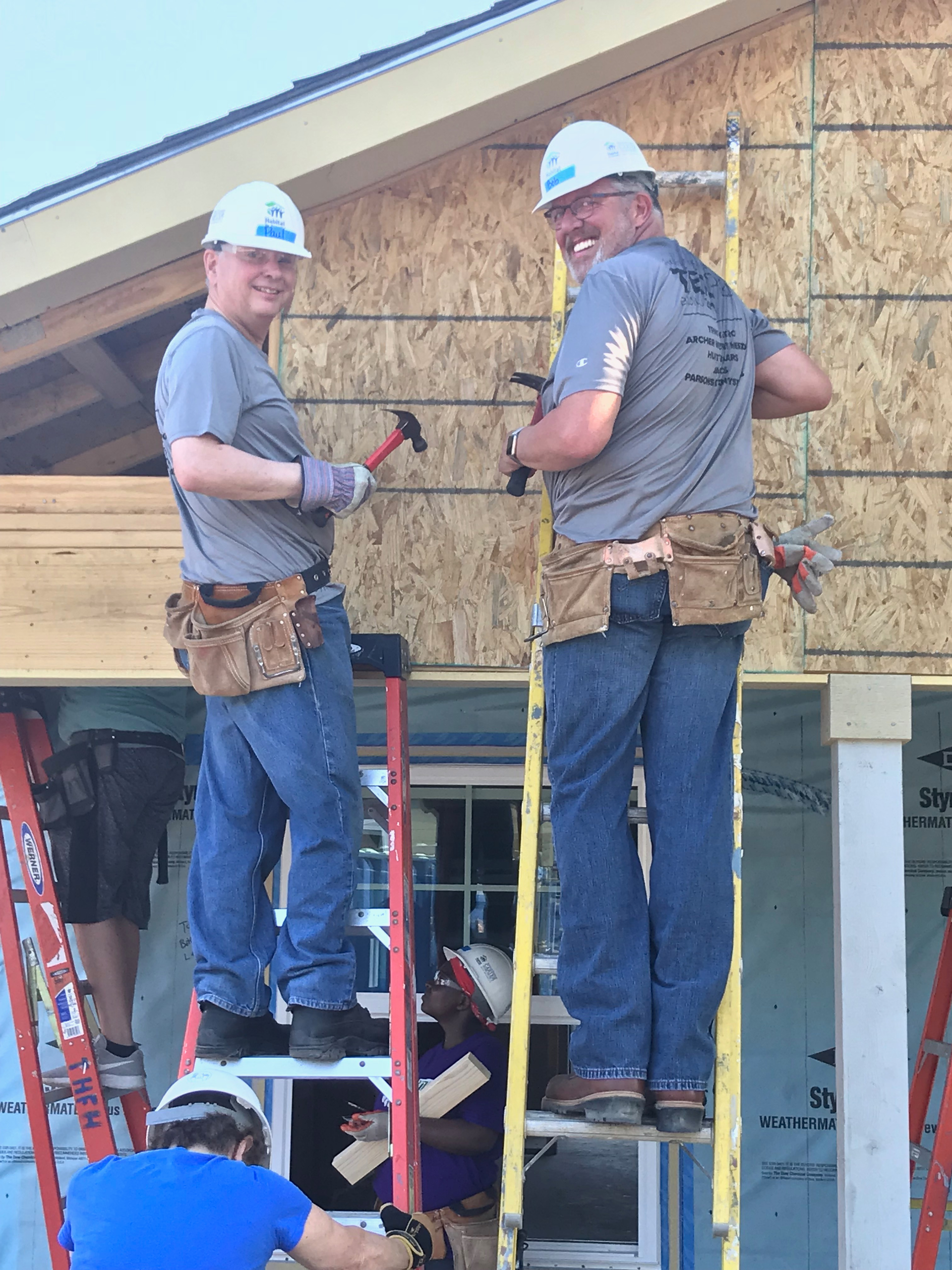Trinity Metro President/CEO Paul J Ballard and Senior Vice President Bob Baulsir working on the TEXRail-sponsored Trinity Habitat for Humanity house in Fort Worth, Texas.