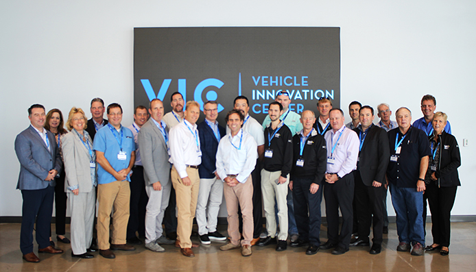 MCI and IMG members gather the Vehicle Innovation Center (VIC), the industry's only tech-lab. From left are Ian Smart, MCI; Patricia Ziska, MCI; Gladys Gillis, The Starline Collection; Chuck Abbott, Gray Line Tennessee; Scott Riccio, Northeast Charter and Tour; Buddy Sload, Krapf Transportation; Brent Maitland, MCI; Dan Martin, Karst Stages; Mike Dixon, Southeastern Stages; Patrick Scully, MCI; Geoffrey Lynch, Hampton Jitney; Brian Parker, Southeastern Stages; Christian Holter, Rochester City Lines; Tom Skinner, Cline Tours; Dan Holter, Rochester City Lines; Frank Leyden, Cline Tours; Robert Lessor, MCI; Greg Gallup, Royal Coach Tours; JP Pelletier, MCI; Steve Batho, MCI; Paul Sanders, Cline Tours; David Warren, New Flyer; and Bronwyn Wilson, IMG.