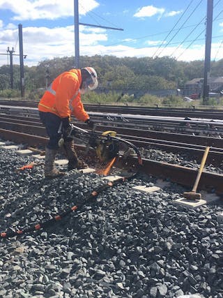 A newly installed rail is welded during work at Harold Interlocking in October 2018.
