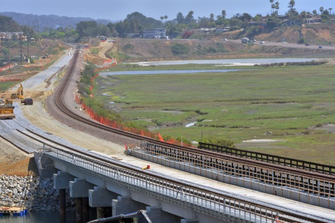 The completed concrete bridge with double track construction occuring in the background can be seen in this photo of the San Elijo Lagoon Double Track Project.