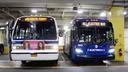 A new, all-electric bus, right, alongside a retired RTS bus in the Michael J. Quill Depot. A new, all-electric bus, right, alongside a retired RTS bus in the Michael J. Quill Depot.