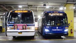 A new, all-electric bus, right, alongside a retired RTS bus in the Michael J. Quill Depot.