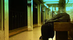 In this 2010 image, a homeless man sleeps on a bench on a NYC subway platform.