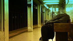 In this 2010 image, a homeless man sleeps on a bench on a NYC subway platform.