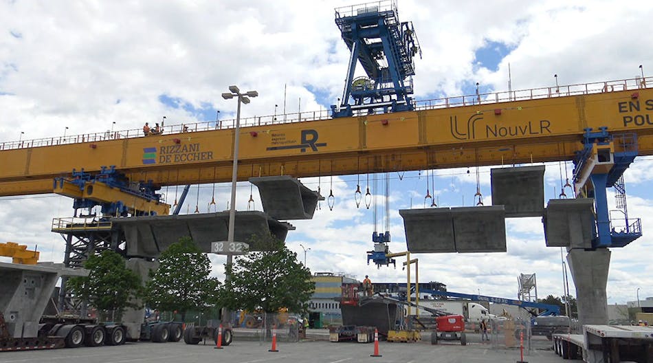 A launching gantry with several prefabricated concrete segments ready for assembly.