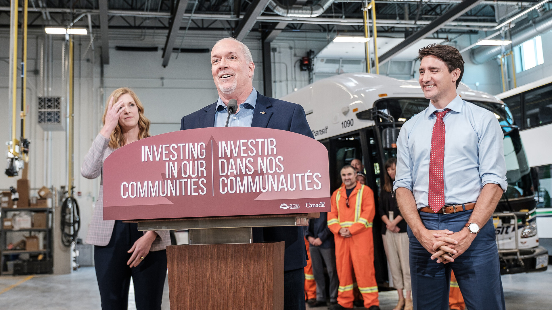 John Horgan, Premier of British Columbia, speaks with, right, Justin Trudeau, Prime Minister of Canada, and, left, Erinn Pinkerton, president and chief executive officer for BC Transit.