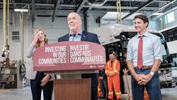John Horgan, Premier of British Columbia, speaks with, right, Justin Trudeau, Prime Minister of Canada, and, left, Erinn Pinkerton, president and chief executive officer for BC Transit.