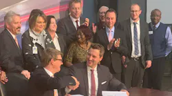 MARTA General Manager/CEO Jeffrey A. Parker, seated left, and Stadler US Inc. CEO Martin Ritter shake hands following a signing ceremony for a 254 new rail car contract.